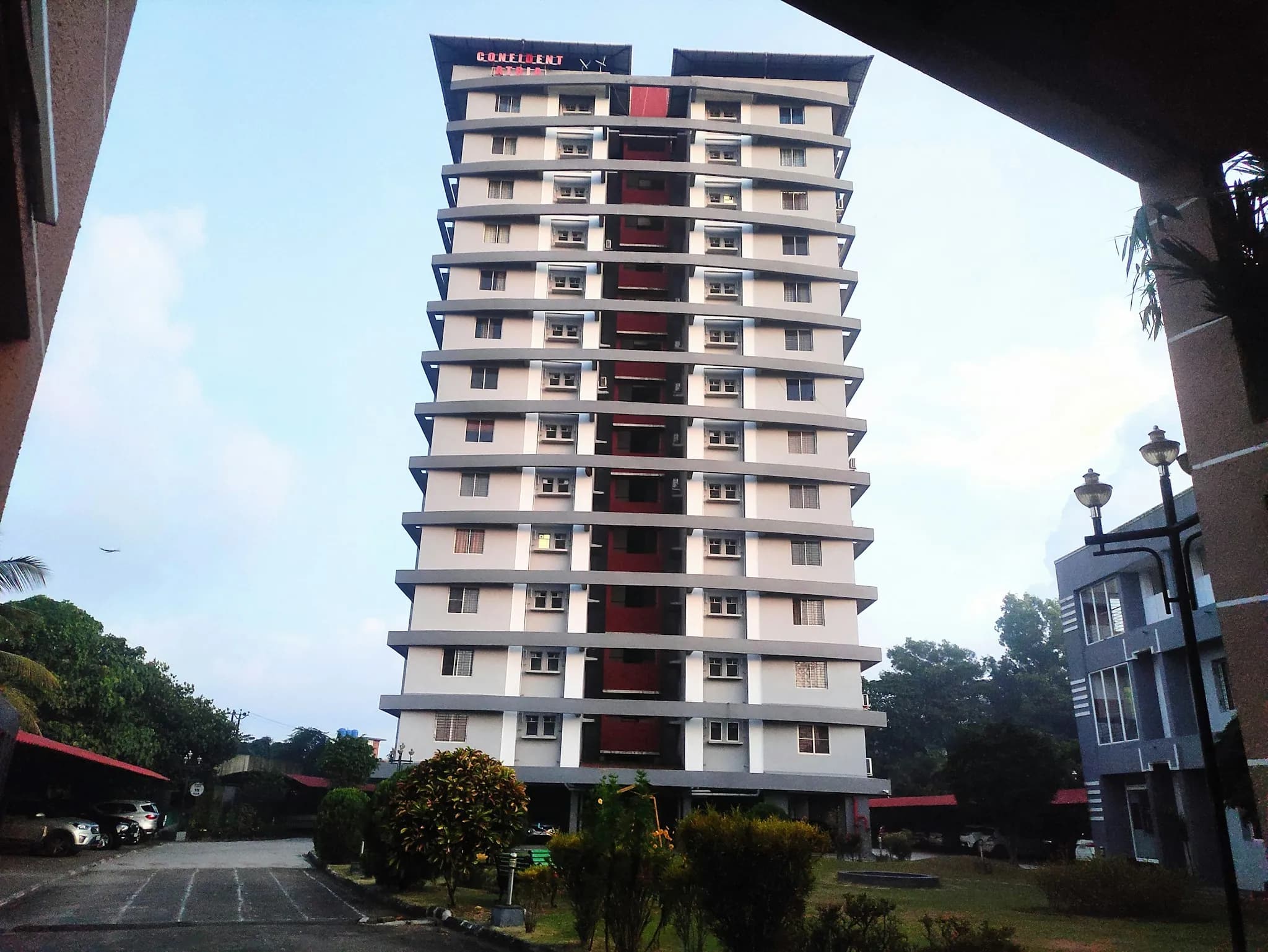 A residential tower against a pale sky