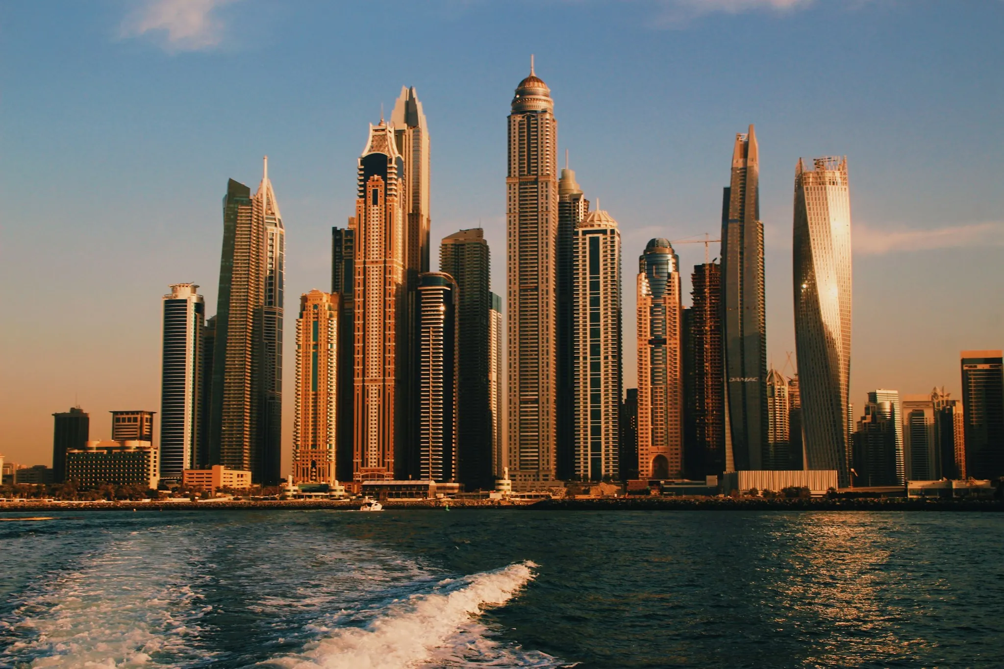 High-rise towers across the water at sunset