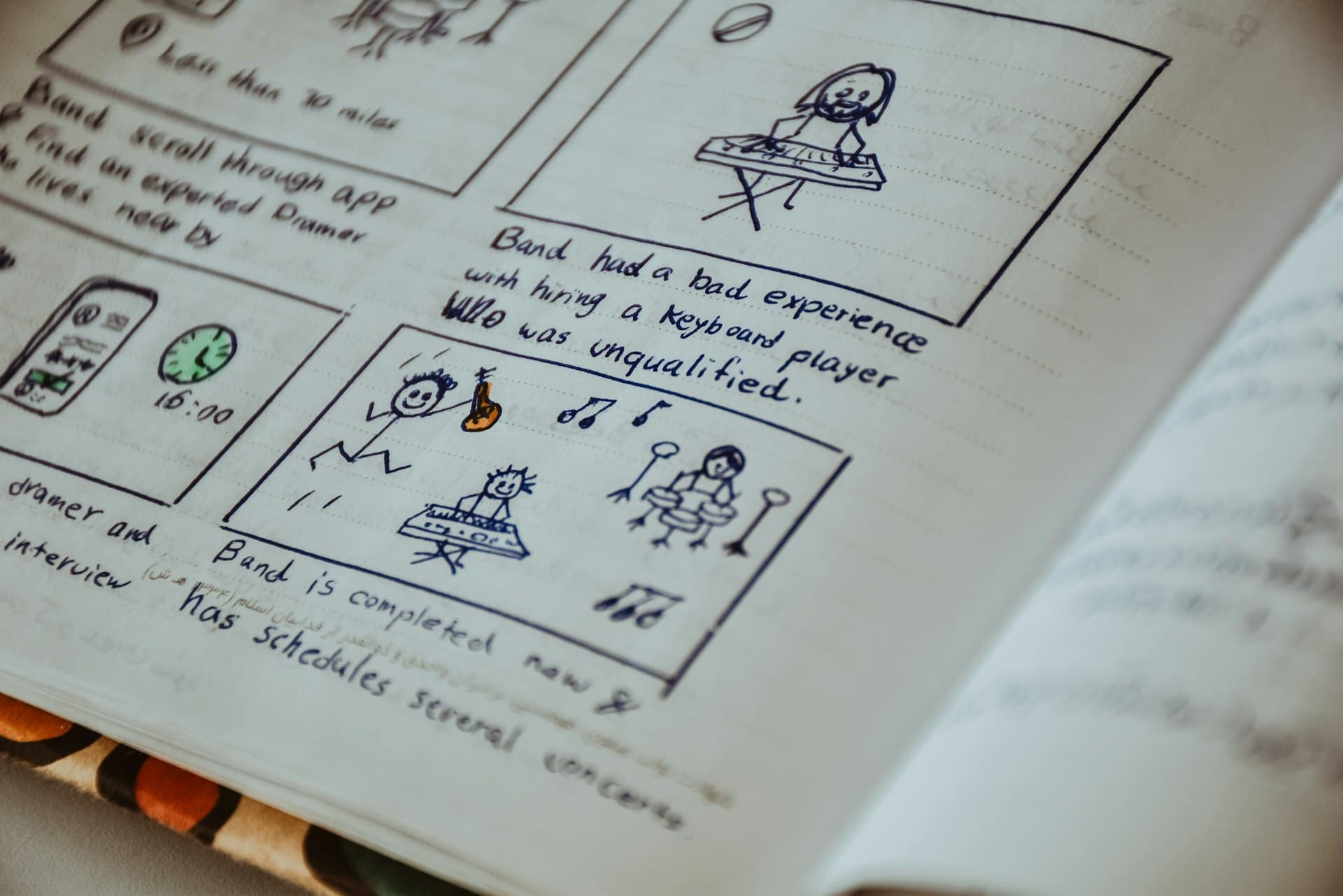 Hand-drawn storyboard panels with stick figures and notes in an open notebook