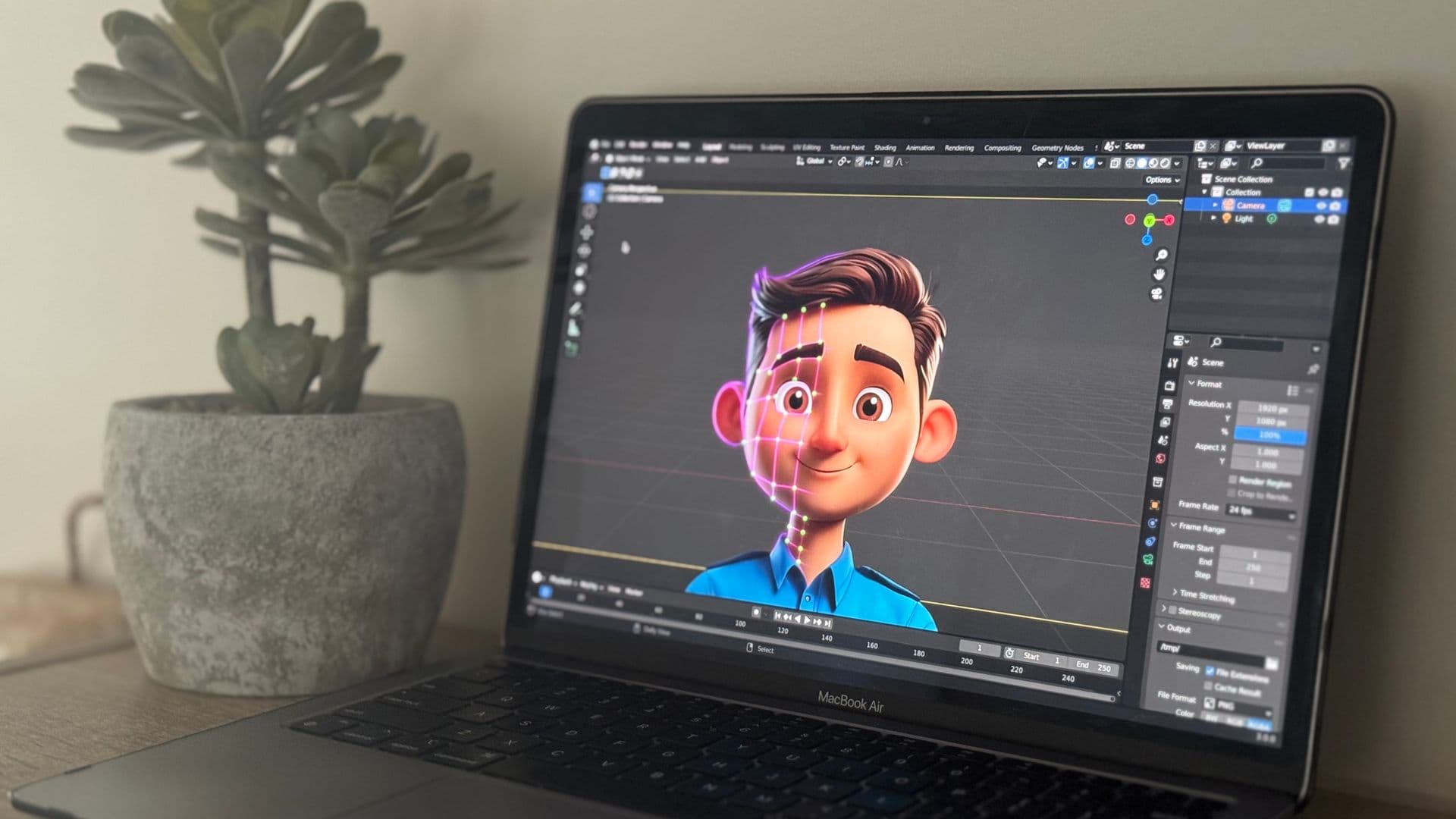 Laptop showing a 3D cartoon character being built in animation software beside a plant