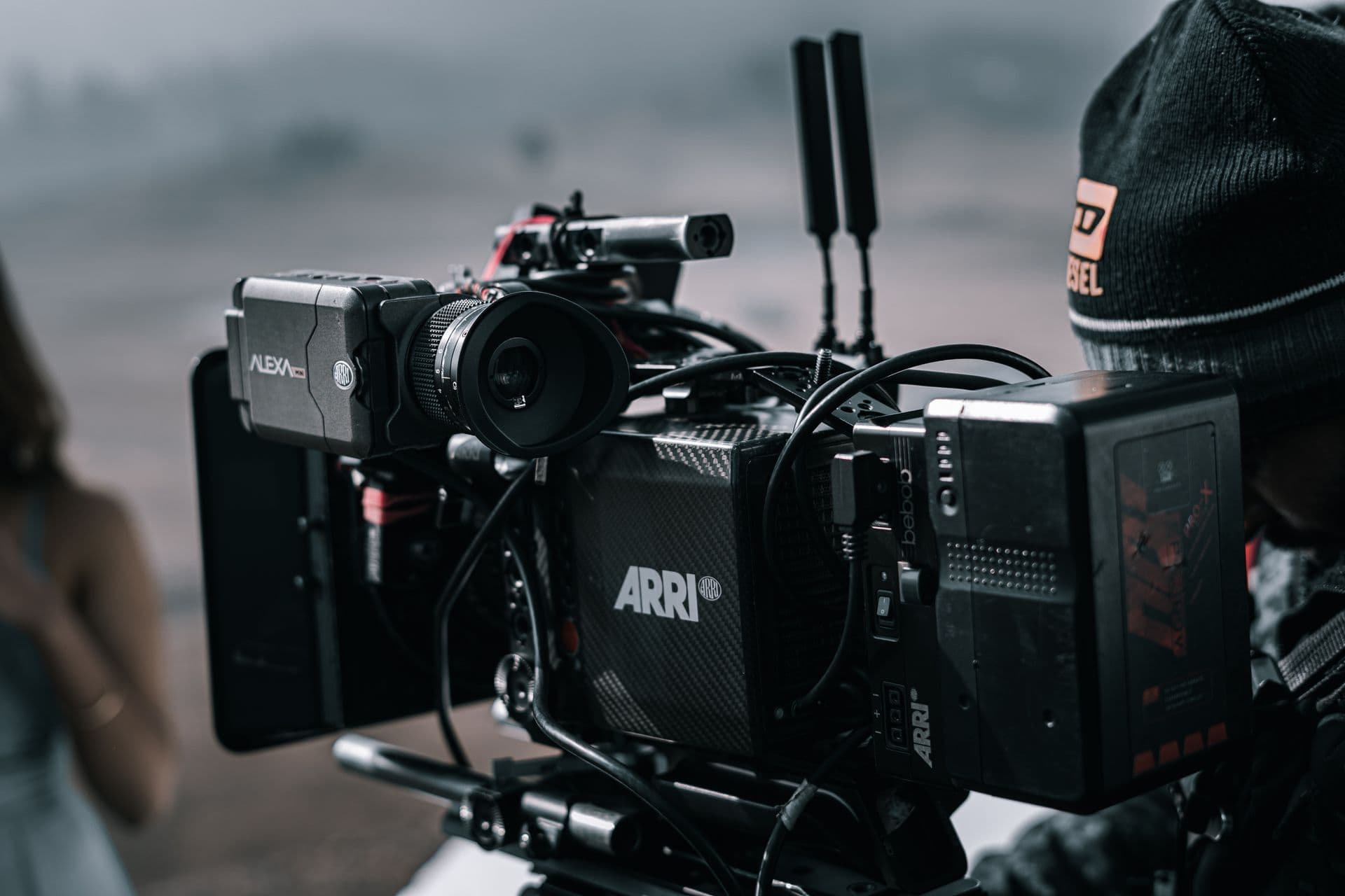 Cinema camera rig with side monitor and wireless antennas on an outdoor film set