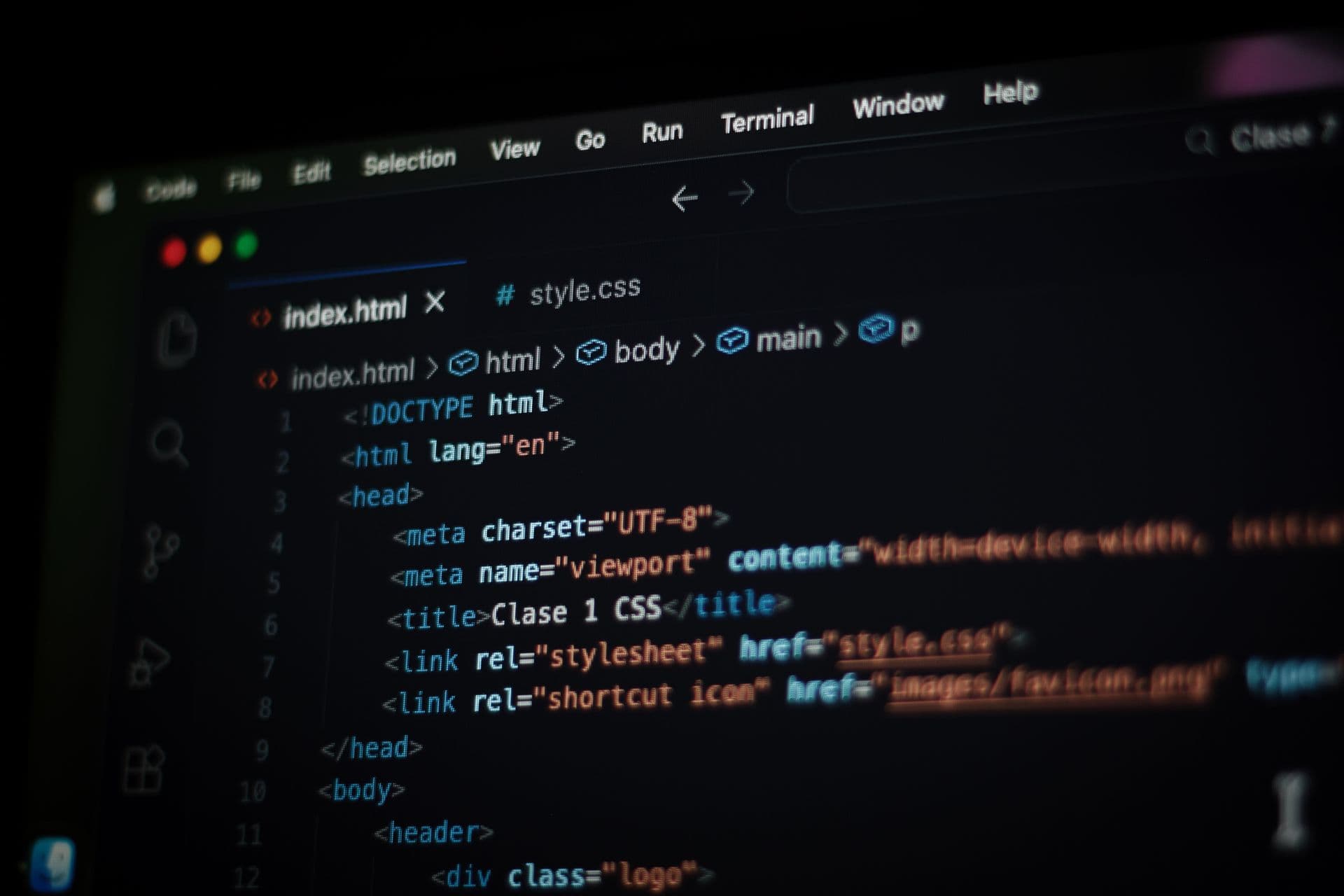 Close-up of HTML code in a dark-mode code editor on a computer screen